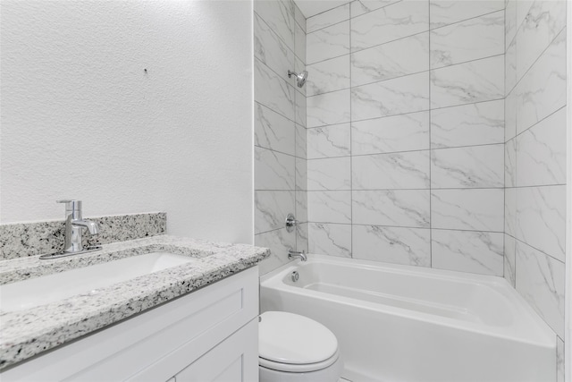 full bathroom with vanity, toilet, and tiled shower / bath combo