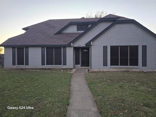 view of front of property with a yard