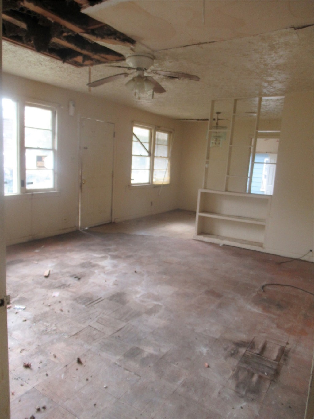 interior space with ceiling fan