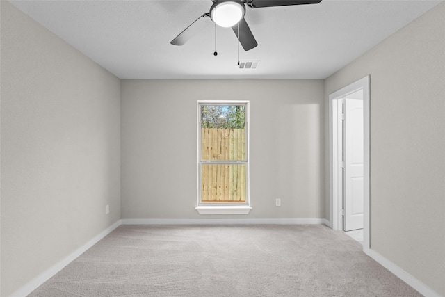 unfurnished room featuring ceiling fan and light carpet