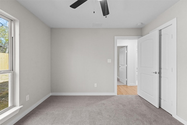 906 Benton St, Bonham, TX 75418 - unfurnished bedroom featuring carpet floors, baseboards, and ceiling fan