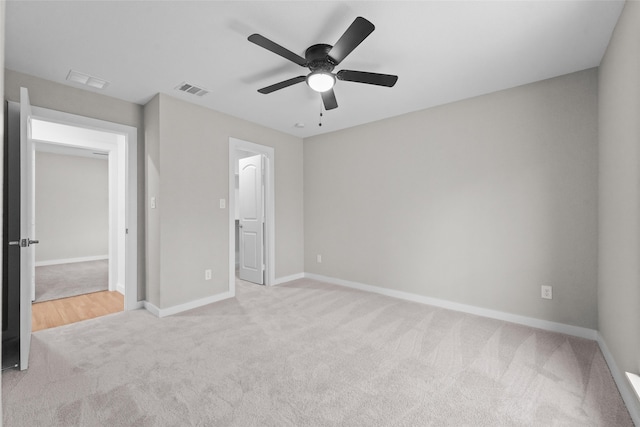 unfurnished bedroom featuring light carpet and ceiling fan