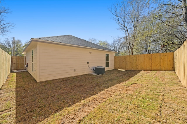 back of house featuring central AC and a lawn