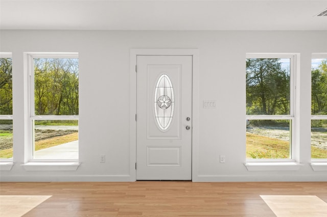 906 Benton St, Bonham, TX 75418 - foyer entrance featuring healthy amount of natural light, light wood-style flooring, and baseboards