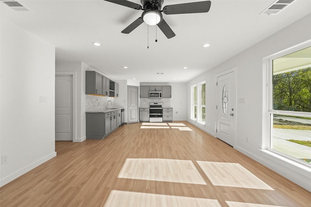 906 Benton St, Bonham, TX 75418 - unfurnished living room featuring a sink, baseboards, light wood finished floors, recessed lighting, and a ceiling fan