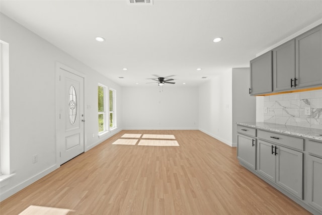 interior space with ceiling fan and light wood-type flooring