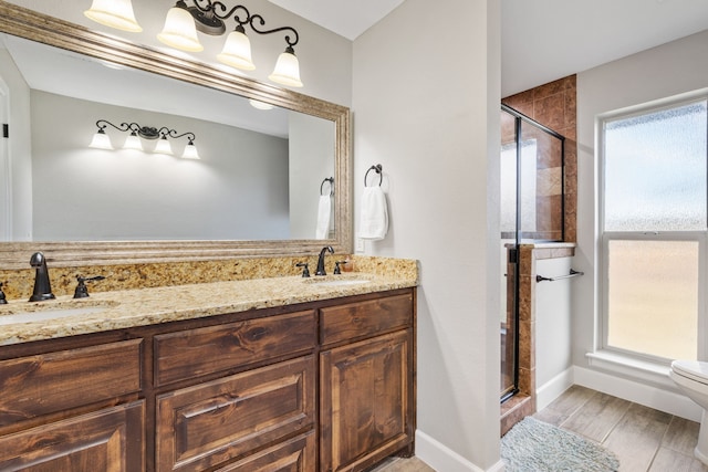 bathroom with walk in shower, vanity, toilet, and hardwood / wood-style flooring