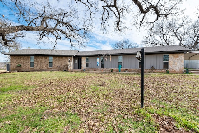 rear view of house featuring a carport and a yard