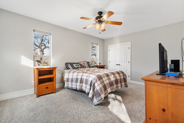 bedroom featuring a closet, ceiling fan, and carpet flooring