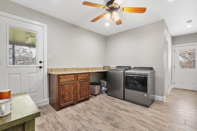 washroom with cabinets, independent washer and dryer, ceiling fan, and light wood-type flooring