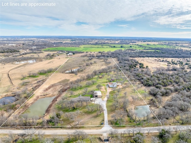 drone / aerial view featuring a rural view and a water view