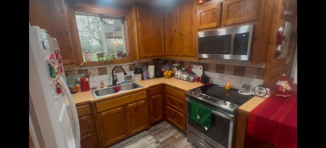 kitchen featuring sink, decorative backsplash, and stainless steel appliances