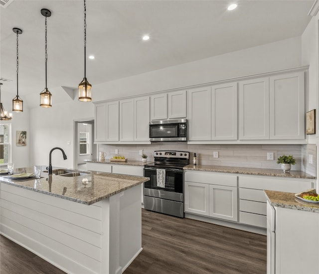 kitchen with white cabinets, pendant lighting, stainless steel appliances, and dark hardwood / wood-style floors