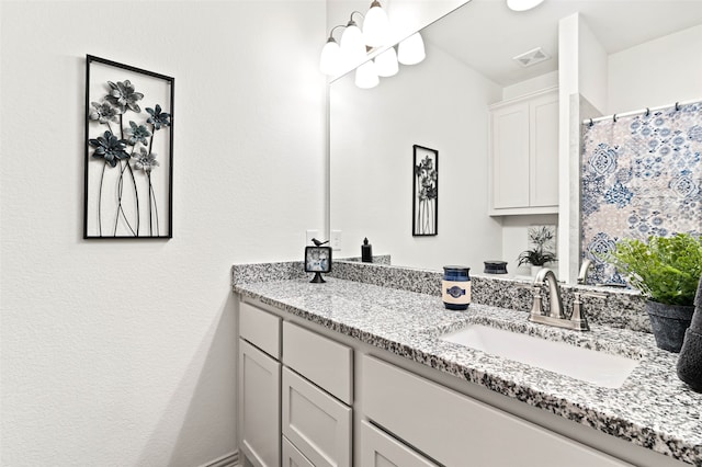 bathroom featuring vanity and curtained shower