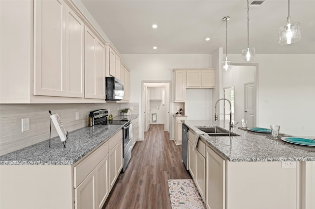 kitchen featuring light stone countertops, stainless steel appliances, sink, pendant lighting, and hardwood / wood-style floors