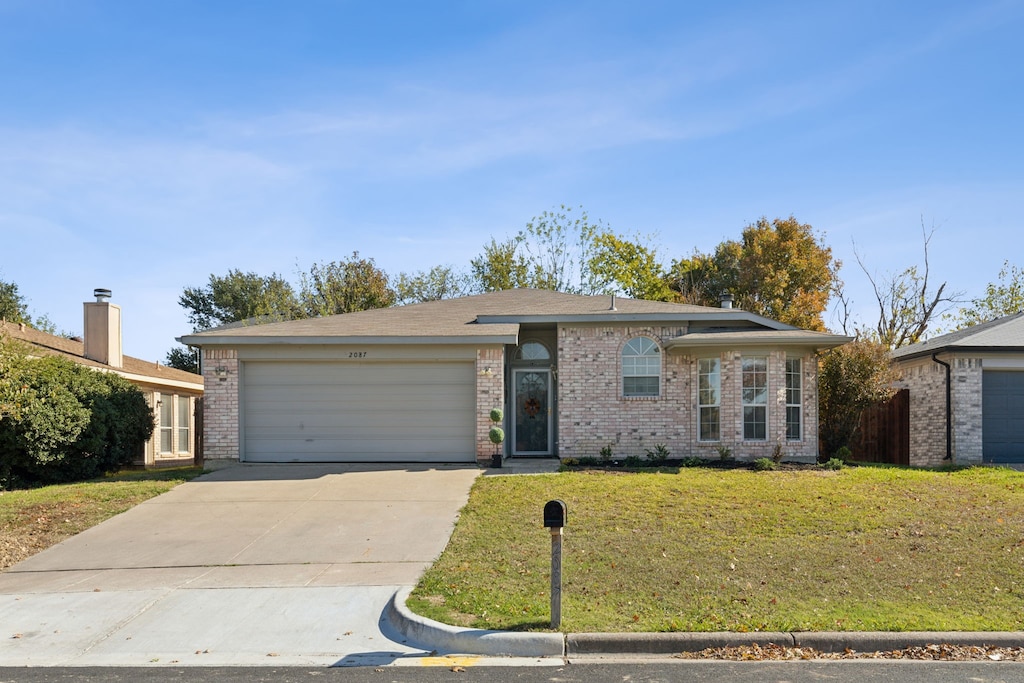 single story home with a garage and a front yard