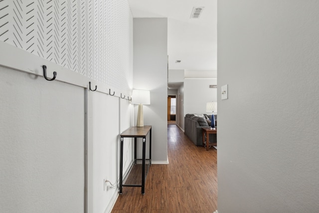 corridor featuring hardwood / wood-style floors and a high ceiling