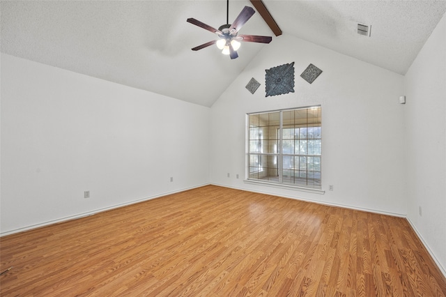 spare room with light wood-type flooring, a textured ceiling, ceiling fan, high vaulted ceiling, and beamed ceiling