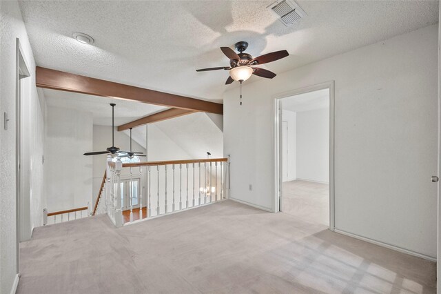 unfurnished room featuring light carpet, ceiling fan, and a textured ceiling