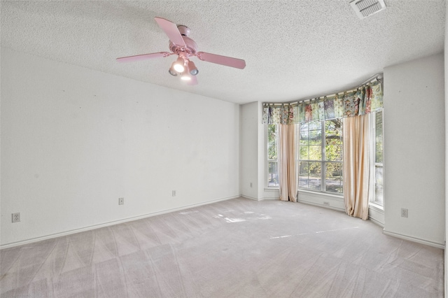 carpeted empty room with a textured ceiling and ceiling fan