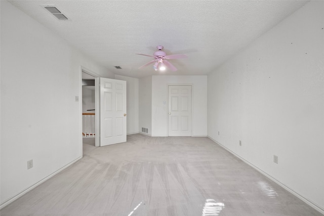 unfurnished bedroom with ceiling fan and a textured ceiling