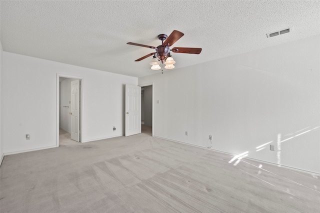 interior space featuring ceiling fan, light carpet, and a textured ceiling