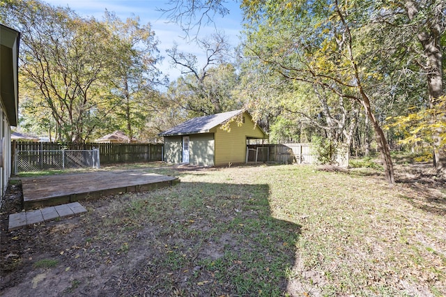 view of yard with a wooden deck and an outdoor structure