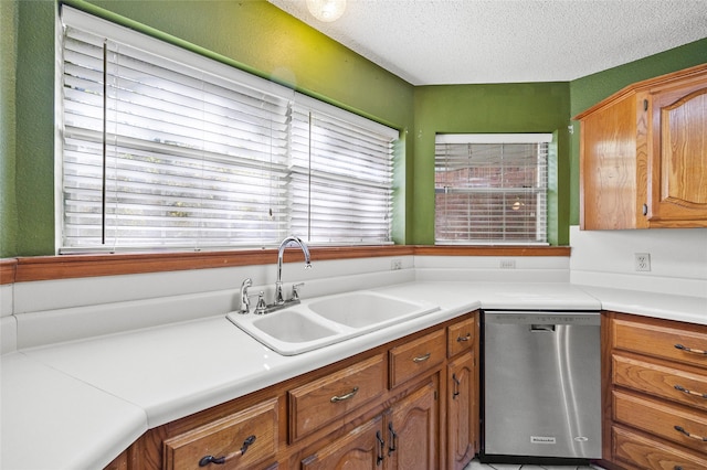 kitchen featuring dishwasher, a textured ceiling, and sink