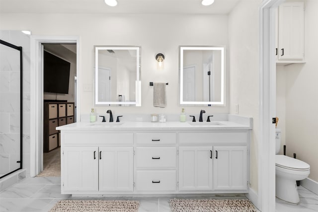 bathroom featuring vanity, toilet, and a shower with shower door