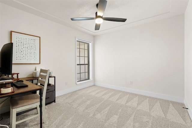 carpeted home office with ceiling fan