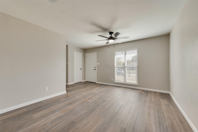 spare room featuring wood-type flooring and ceiling fan