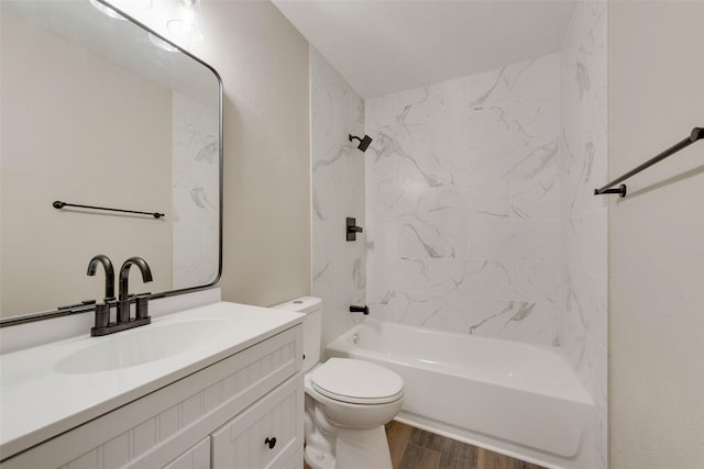 full bathroom with vanity, wood-type flooring, tiled shower / bath combo, and toilet