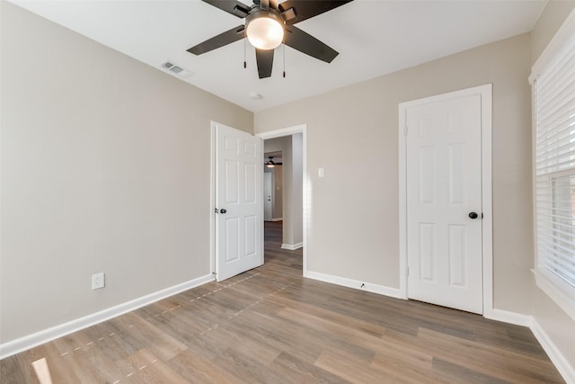 unfurnished bedroom featuring ceiling fan and light wood-type flooring