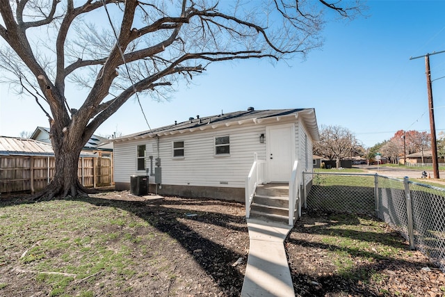 back of house featuring central air condition unit