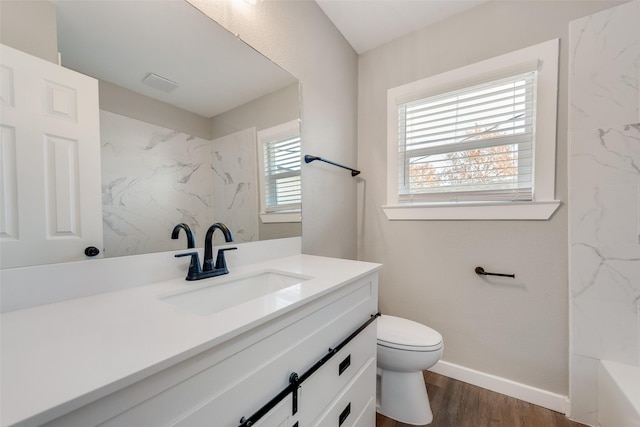 bathroom with hardwood / wood-style floors, vanity, and toilet