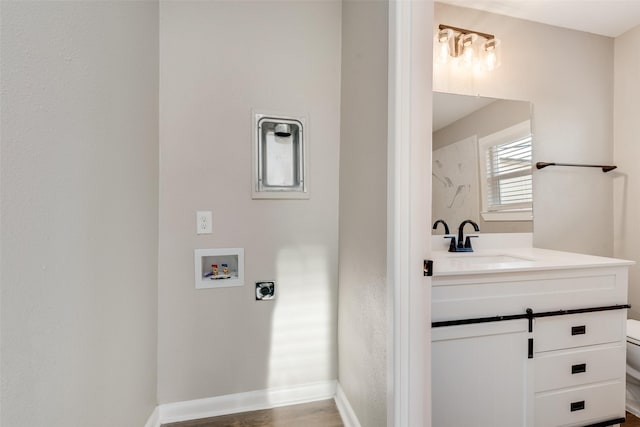 bathroom featuring hardwood / wood-style floors, vanity, and toilet