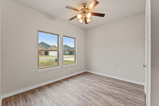 spare room featuring ceiling fan and light hardwood / wood-style flooring