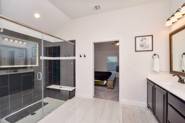 bathroom with an enclosed shower, vanity, ceiling fan, and lofted ceiling