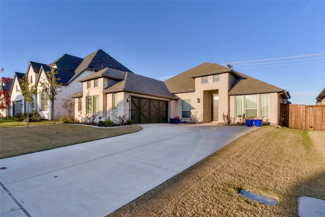 view of front of home featuring a front yard and a garage