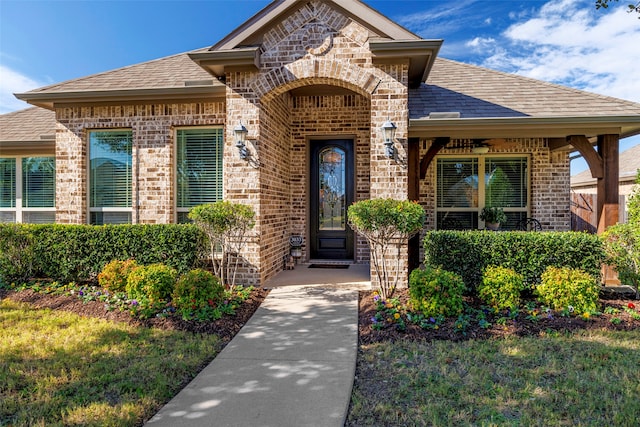 entrance to property with a lawn