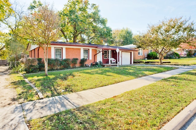 ranch-style house featuring a garage, a front yard, and brick siding