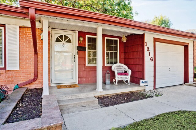 property entrance with a porch and a garage