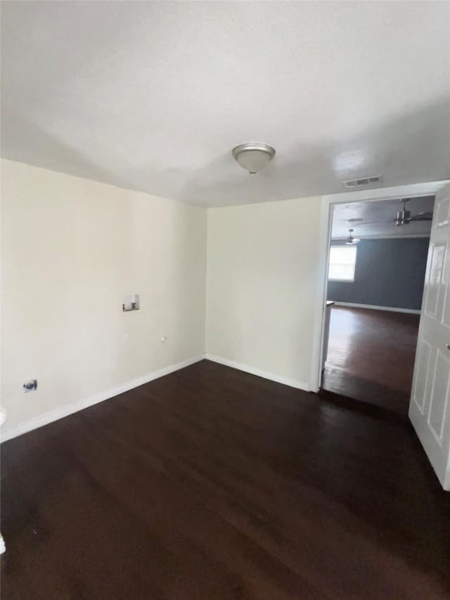 spare room with dark hardwood / wood-style floors