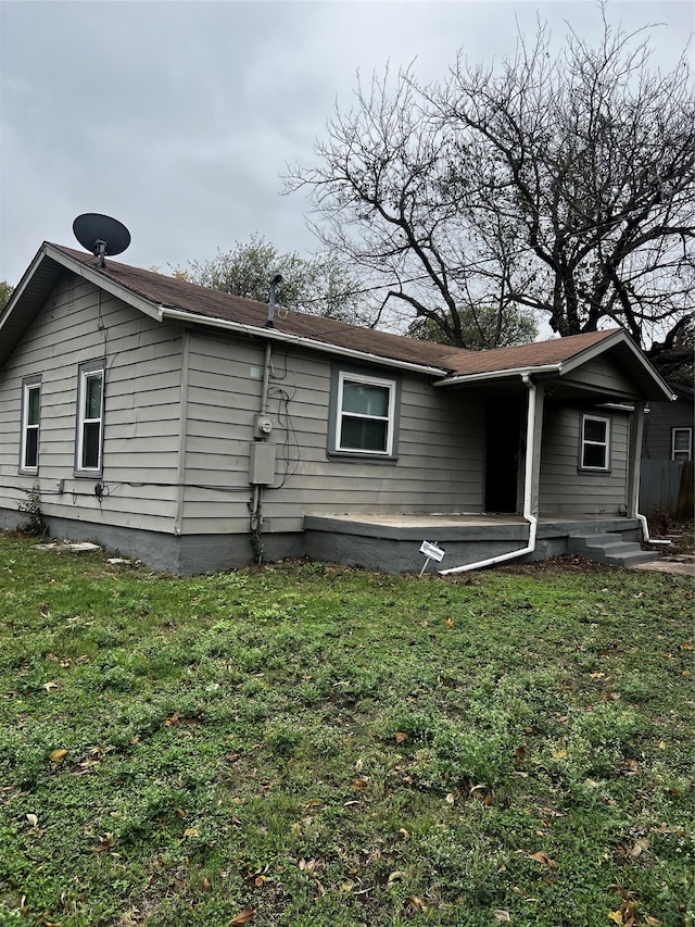 back of house with a yard