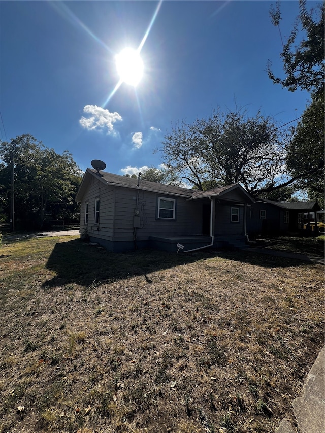 rear view of house featuring a lawn