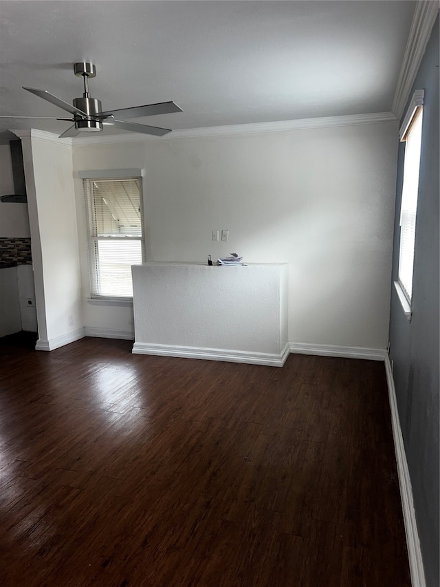 unfurnished room featuring dark hardwood / wood-style flooring, ceiling fan, and ornamental molding