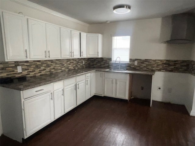 kitchen featuring white cabinets, sink, wall chimney exhaust hood, and dark hardwood / wood-style floors