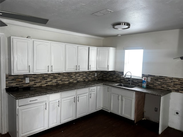 kitchen with white cabinets, decorative backsplash, dark wood-type flooring, and sink