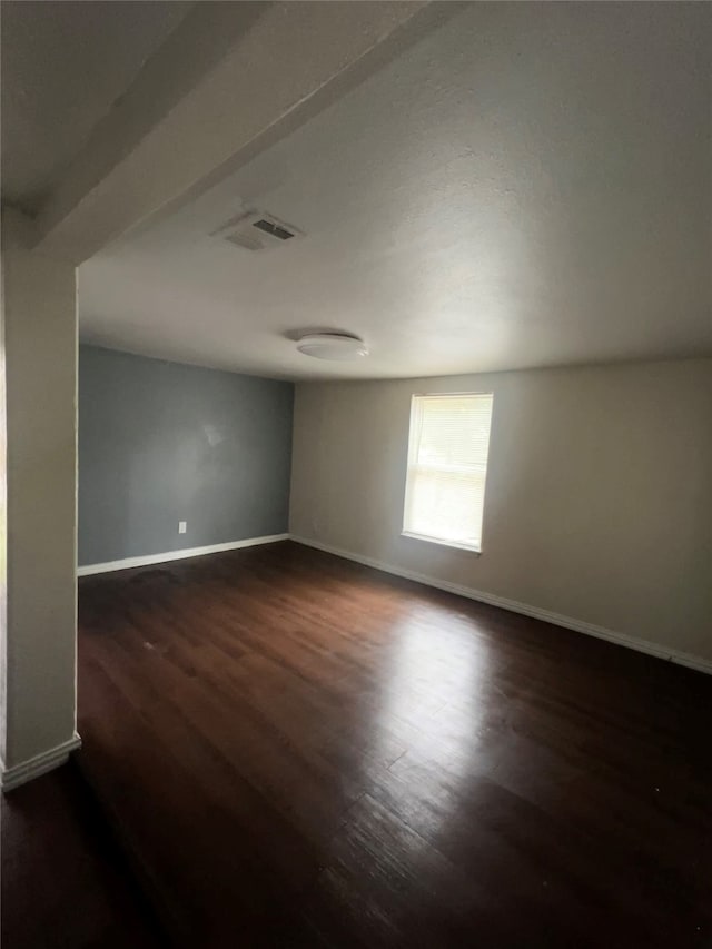 unfurnished room featuring dark wood-type flooring