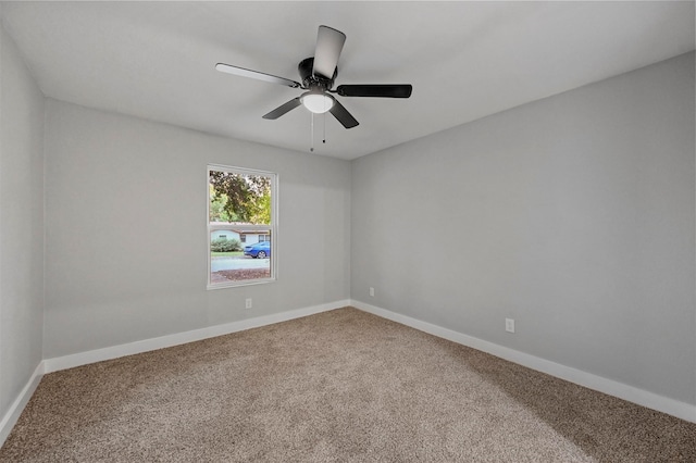 unfurnished room featuring ceiling fan and carpet